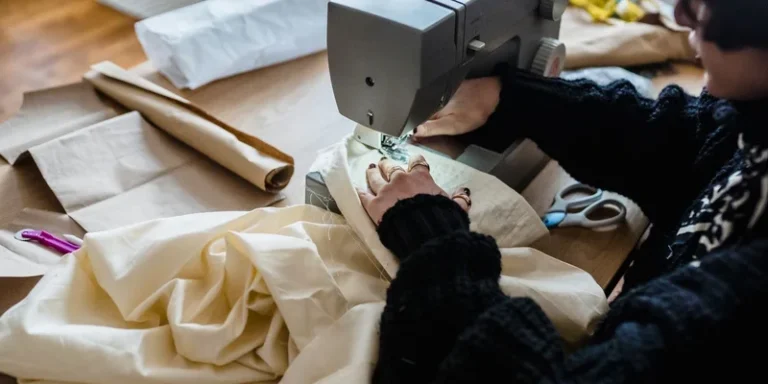 Woman working with sewing machine in a textile studio