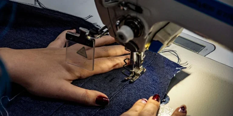 Detailed shot of sewing denim fabric on a sewing machine
