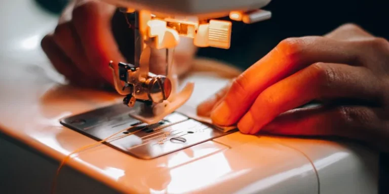Detailed view of hands using a sewing machine