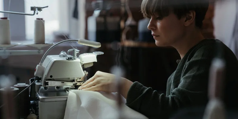 Woman using an overlock machine in a sewing workshop