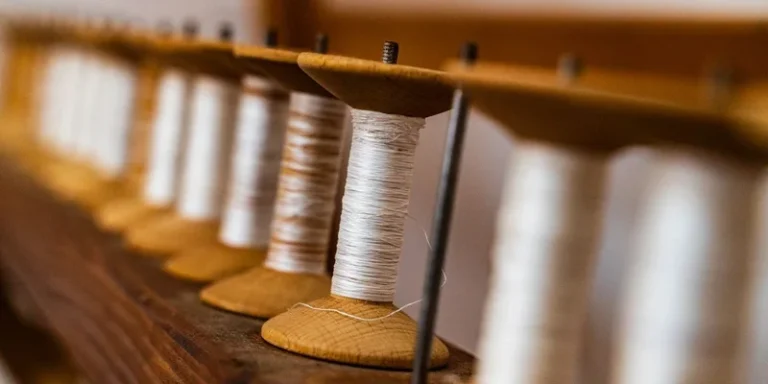 Close-up of vintage wooden spools filled with cotton threads