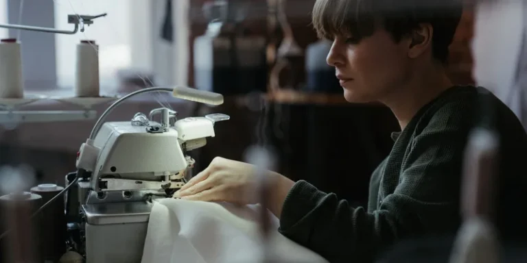Woman using an overlock machine in a sewing workshop