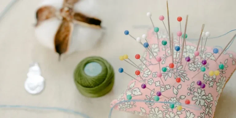 Colorful pins and threads on a sewing workspace