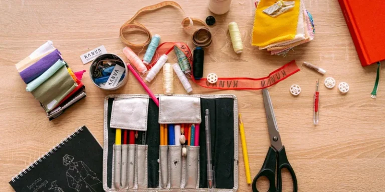 Flat lay of a sewing kit with threads, scissors, and fabric for creative crafting