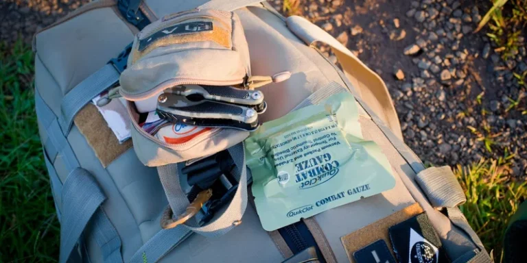 Essential outdoor gear featuring a backpack and first aid kit ready for adventure