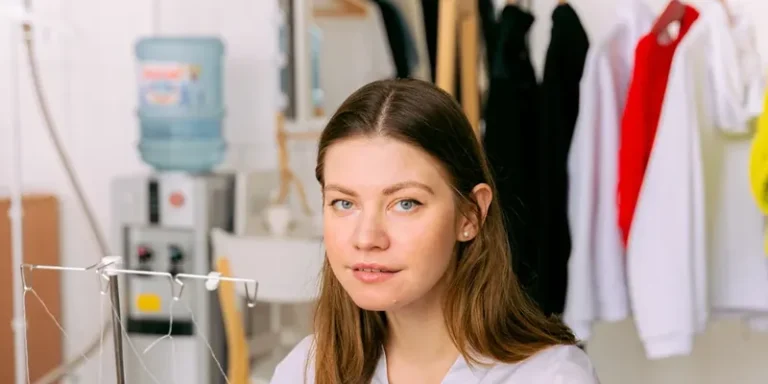 Sewist feeding denim through a serger