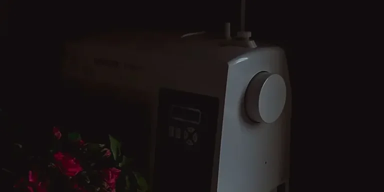 Singer sewing machine with fashion sketches in warm light