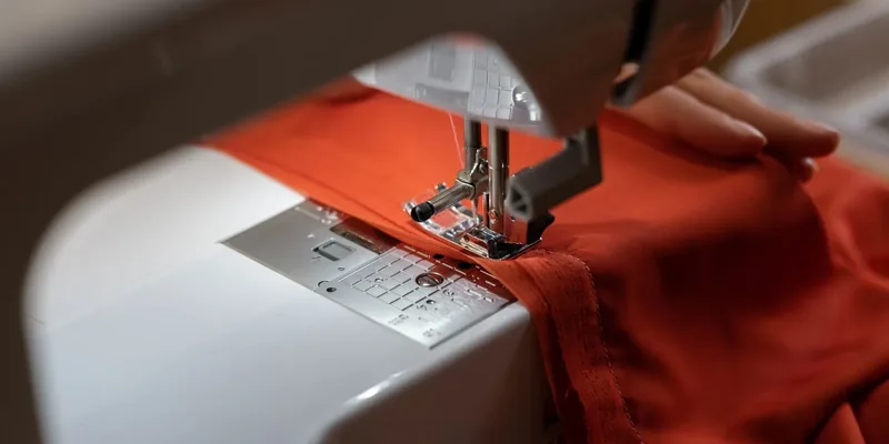 Sewing machine stitching red fabric