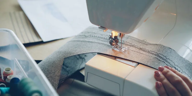 Detailed view of a sewing machine stitching fabric