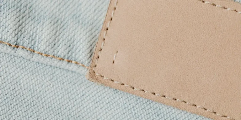 Detailed view of denim fabric with a leather patch