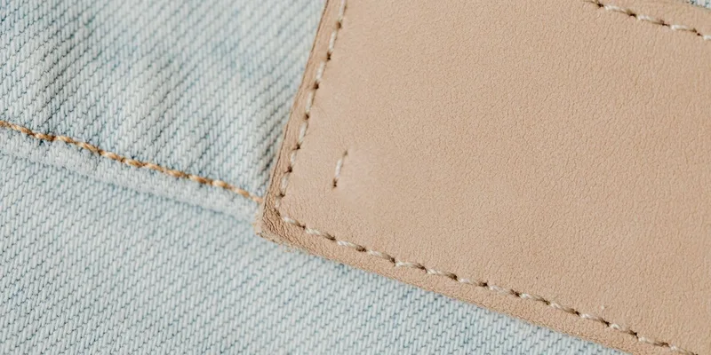Detailed view of denim fabric with a leather patch
