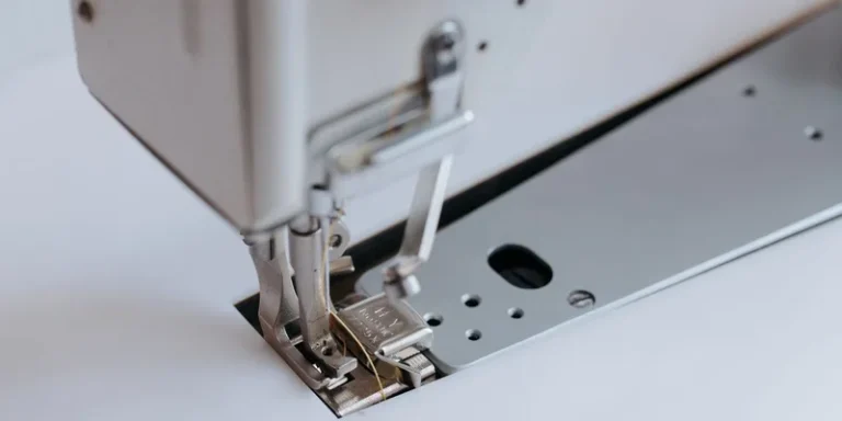 Detailed view of a sewing machine with focus on the needle and presser foot