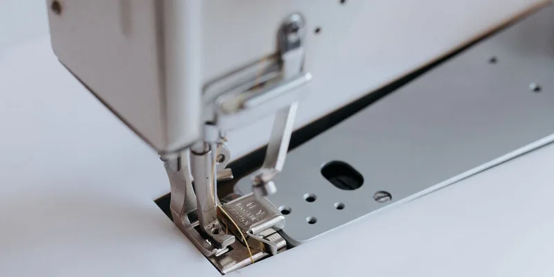 Detailed view of a sewing machine with focus on the needle and presser foot